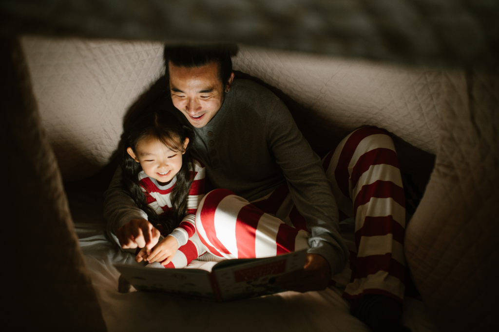 The purpose of this photo is to illustrate the importance of creating bedtime routines that support healthy sleep habits for children. It shows a nurturing moment between parent and child, highlighting how consistency and bonding at night contribute to better rest.