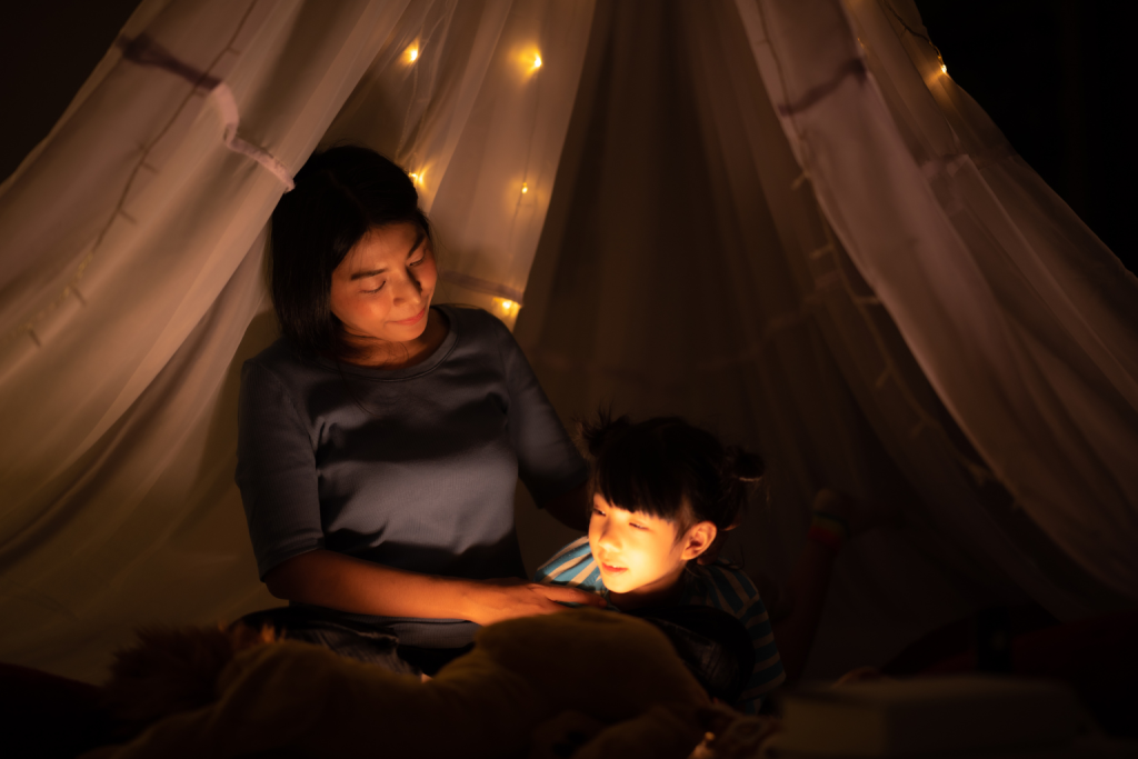 The photo highlights the bond between parent and child, showing how storytelling and quiet moments support Calming Activities Before Sleep for Kids by creating a peaceful bedtime environment.