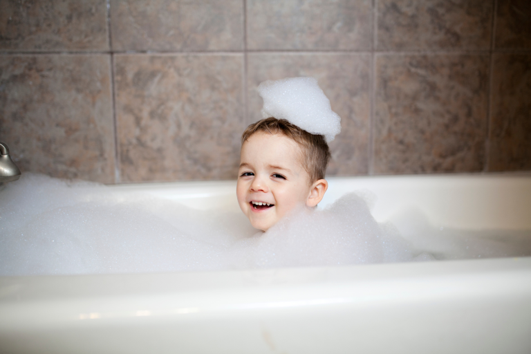 The photo supports content about the bedtime routine for toddlers by showing a fun and calming bath time moment, helping to visually reinforce the importance of winding down before sleep.