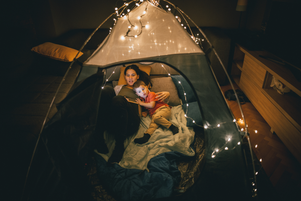 This photo enhances content on bedtime stories, showing a cozy, intimate moment between a parent and child, ideal for winding down before sleep.