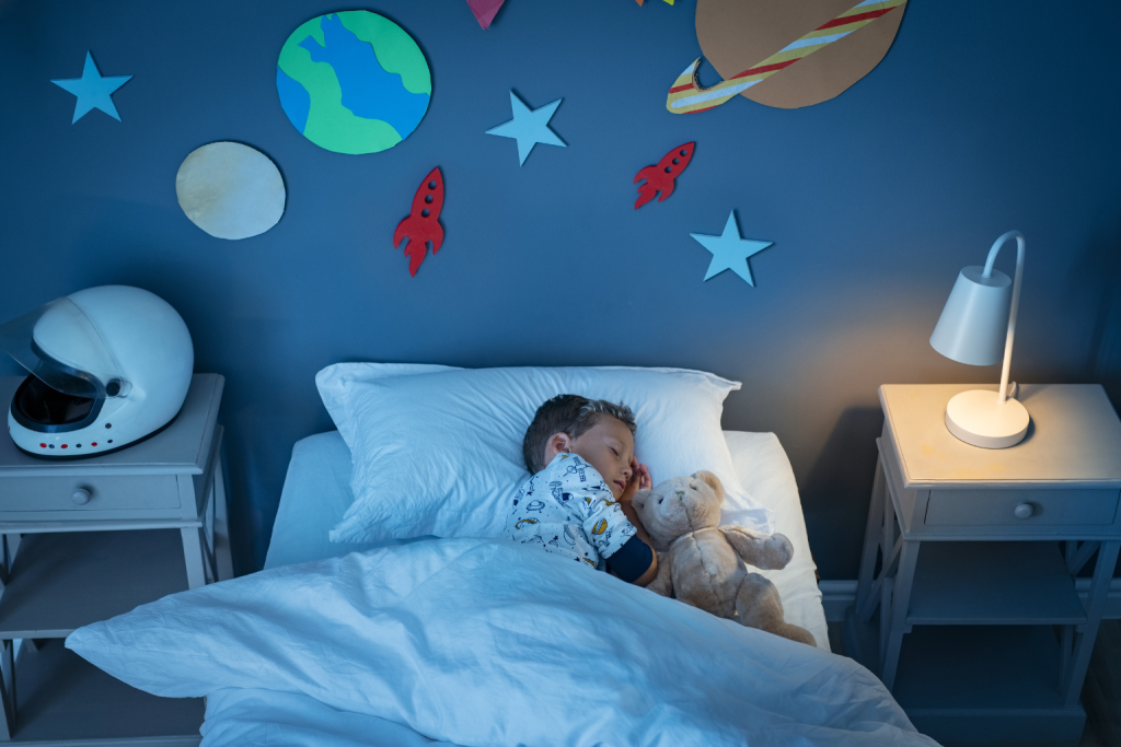 The purpose of this photo is to illustrate how a calming bedtime environment helps develop healthy sleep habits for toddlers. It highlights the importance of routine and a soothing bedroom setup in supporting better sleep quality.