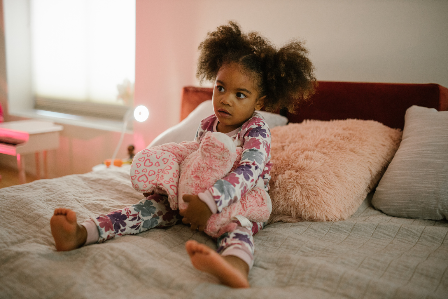 This photo supports content on bedtime toddler sleep regression by showing a toddler who looks alert or restless during bedtime, visually representing the struggle to settle down.