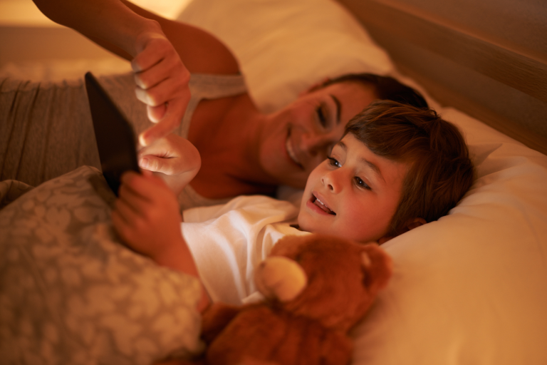 Parent reading bedtime story as part of a calming sleep routine.
