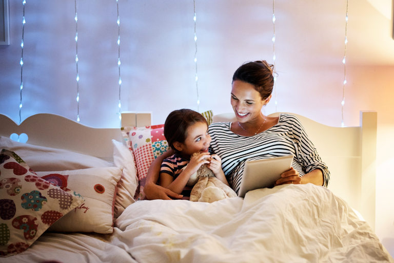Parent guiding child through a screen-free bedtime routine.