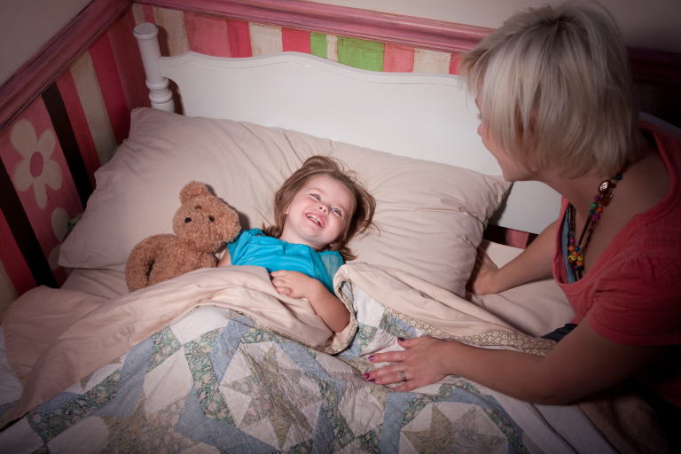 Parent calmly guiding child to bed without turning bedtime into a struggle.
